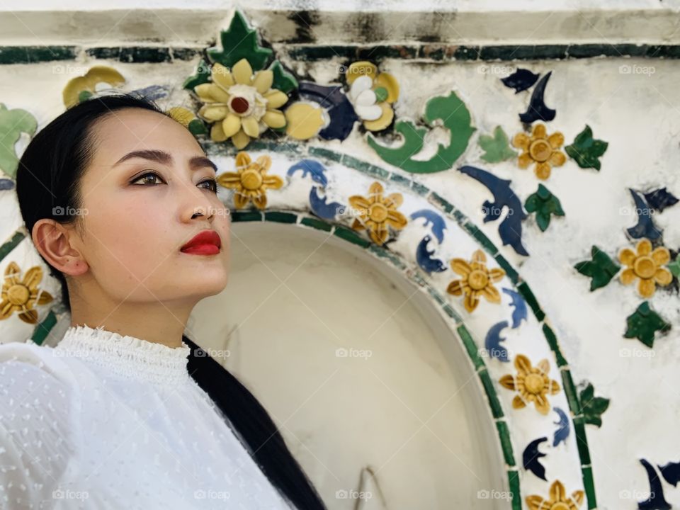 Asian women with black hair brown eyes and red lipstick looks 