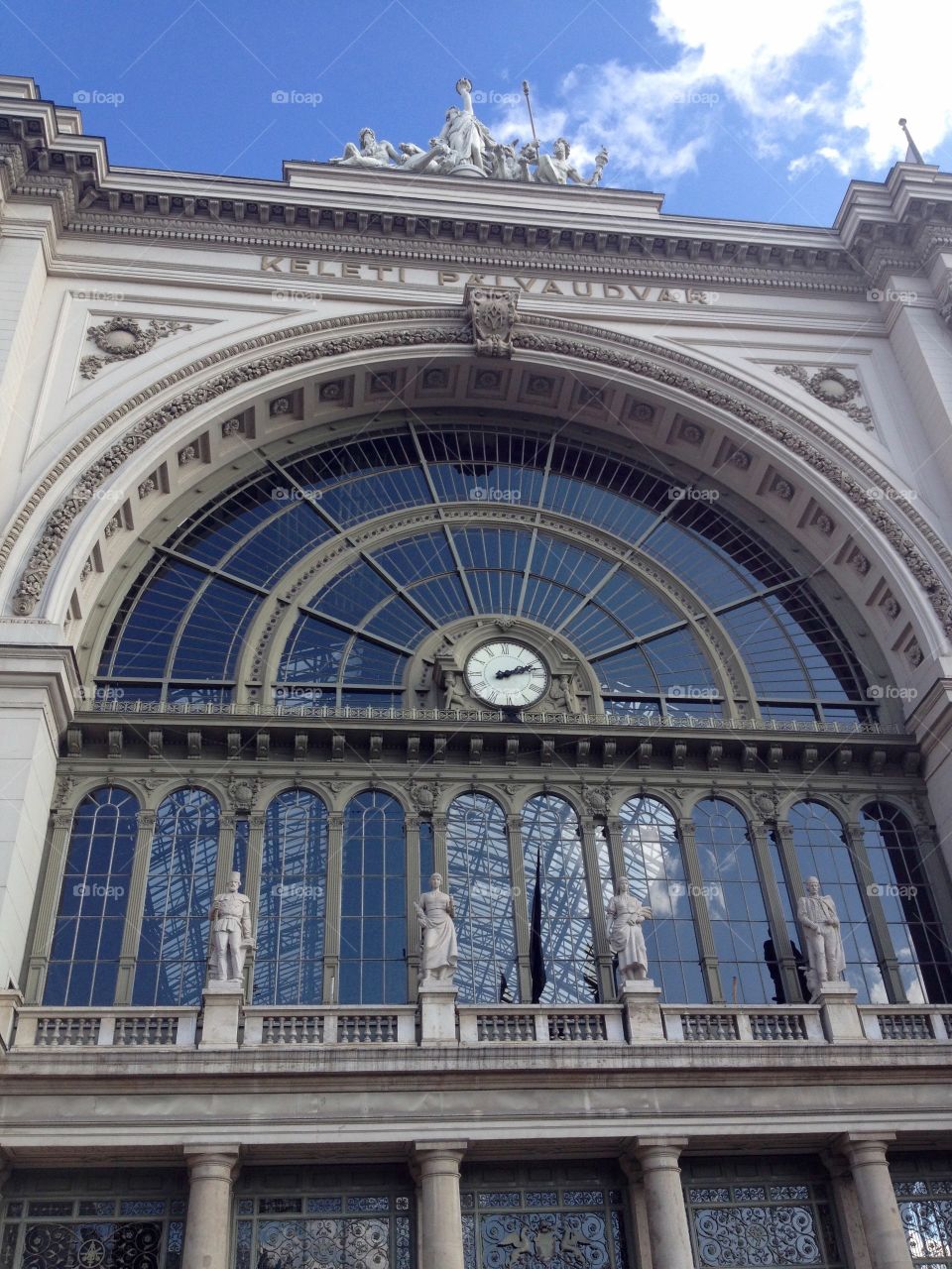 Facade with window and clock of a railway station in Budapest