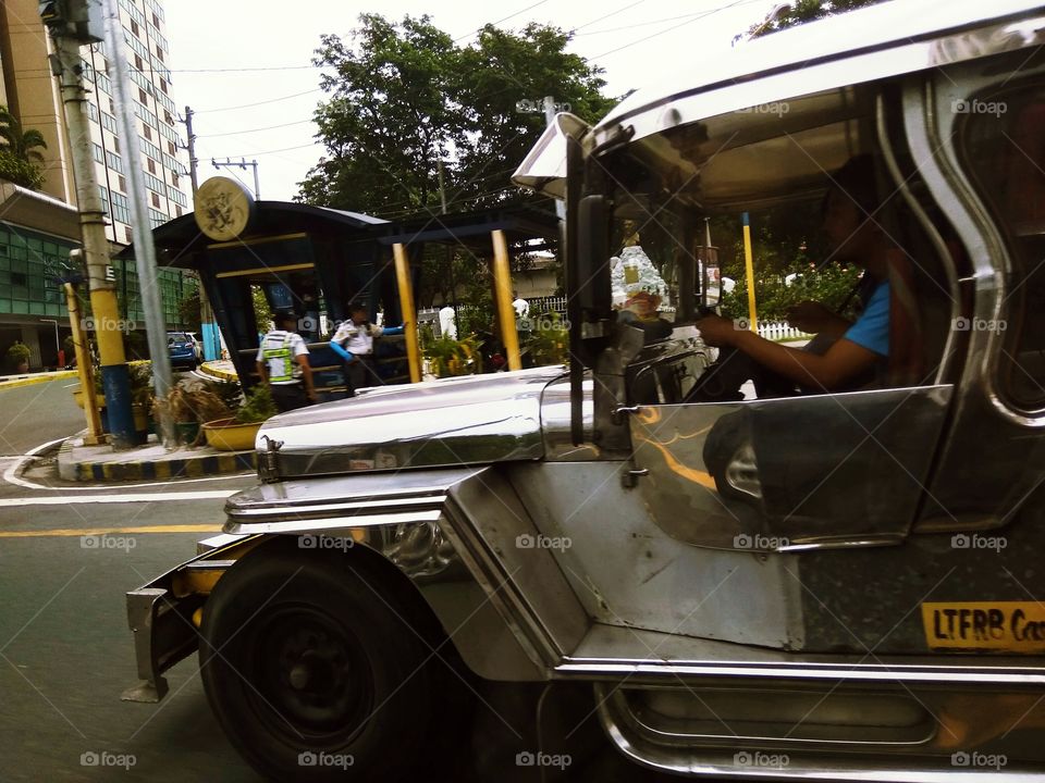 King of the road. Jeepney in the Philippines with traffic enforcers. Street Photography.