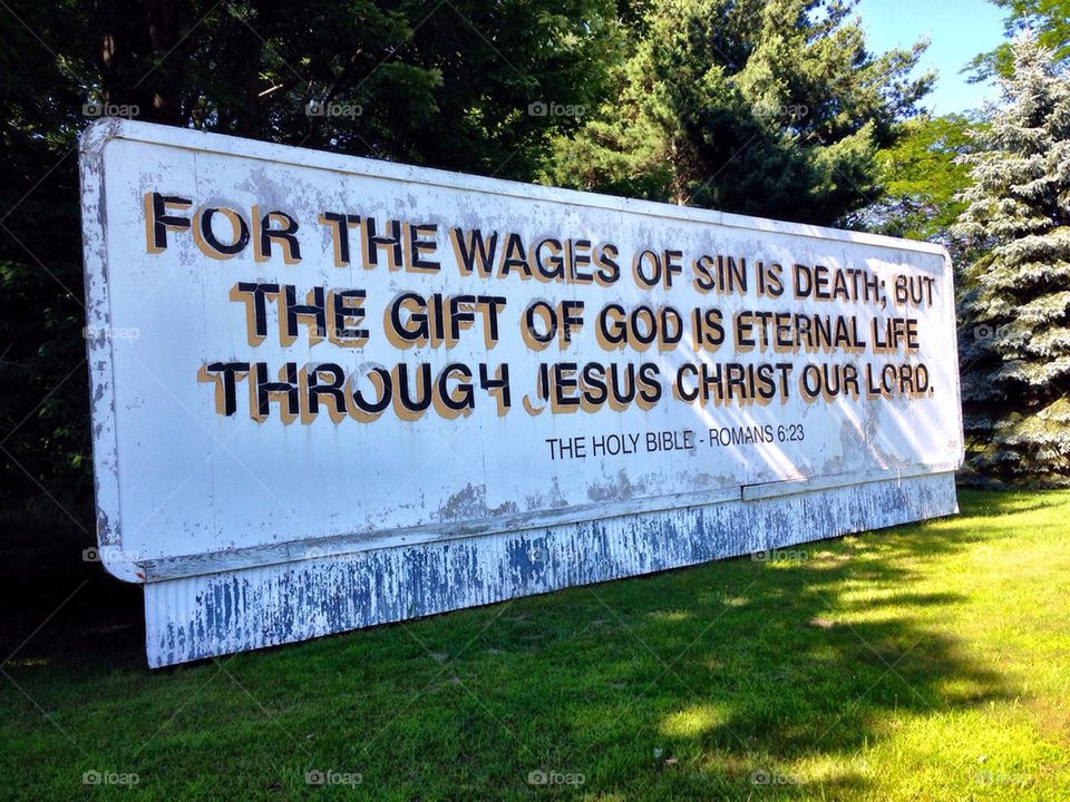 Romans 6:23. Old sign that is still standing. Bible scripture sign. 