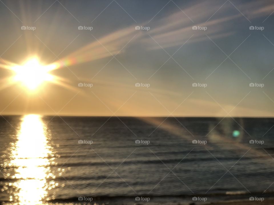 An out of focus photo of a sunset at a beach in Mexico