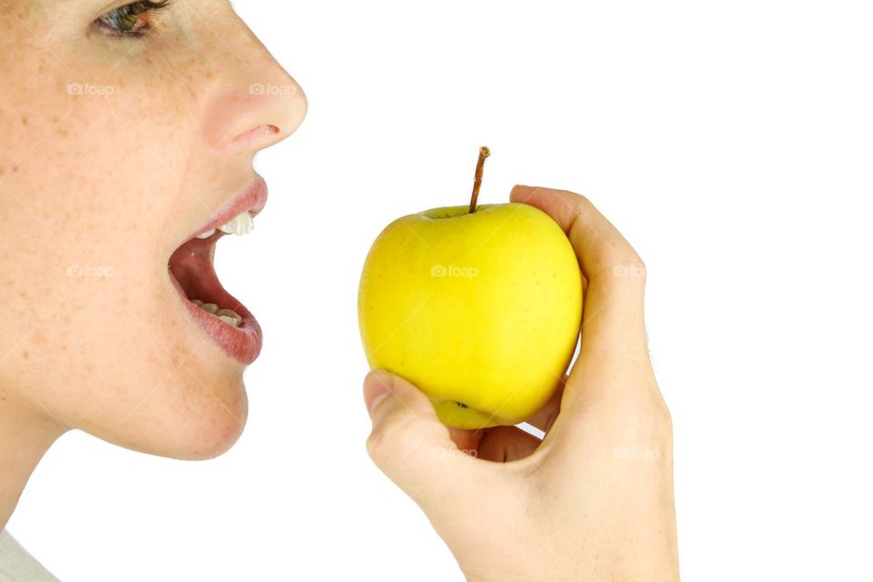 Girl taking a bite of an apple