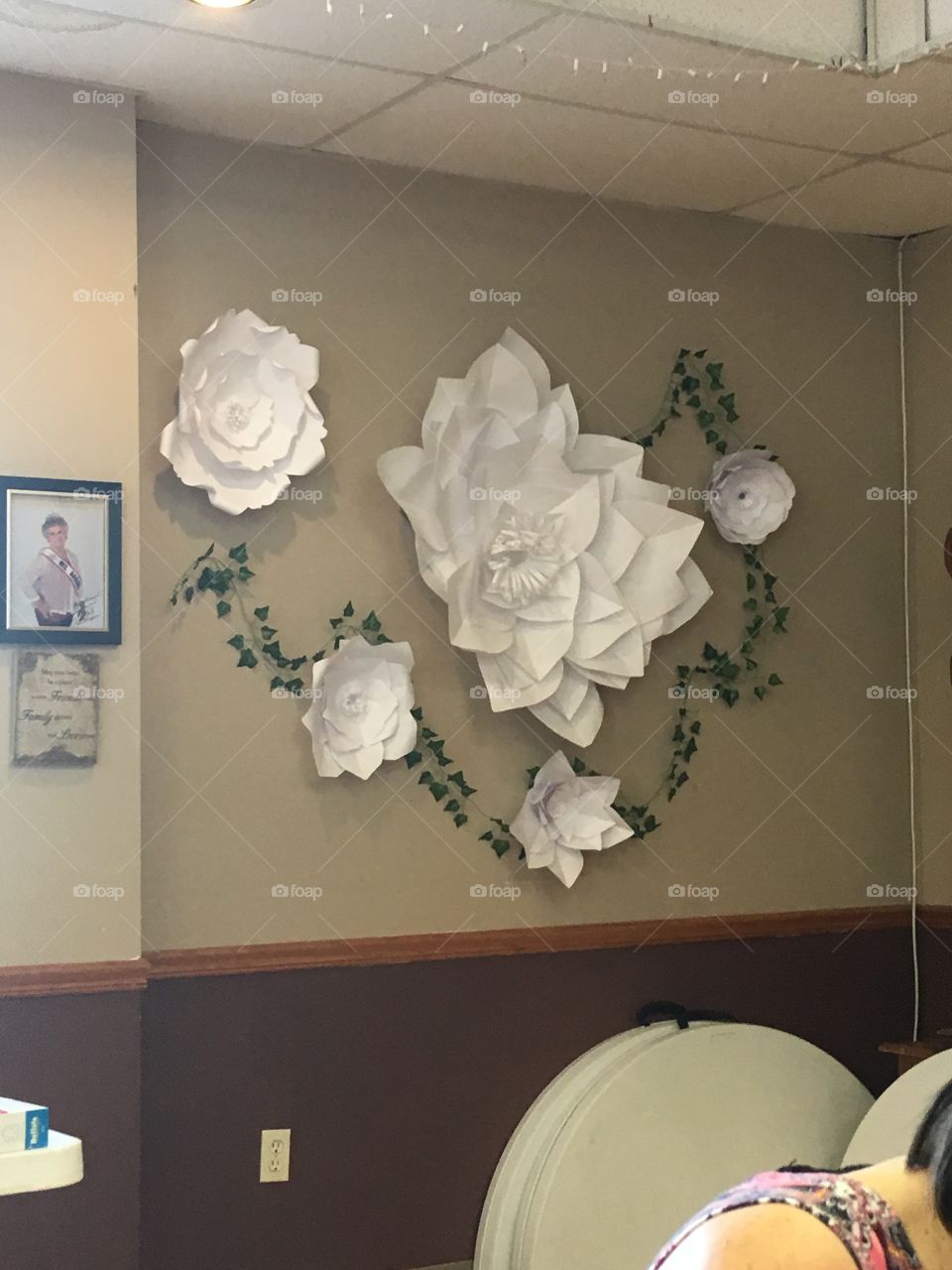 Hand made flower art made out of paper on the wall at a senior center in another town.