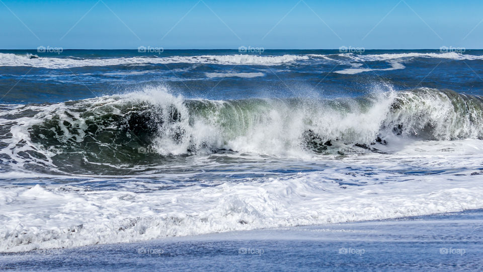 Sea waves splashing on beach