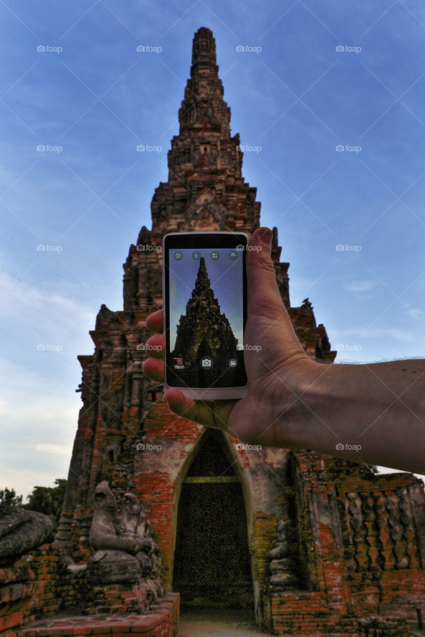 taking picture of Thai Buddhist temple with mobile phone in Ayudhaya