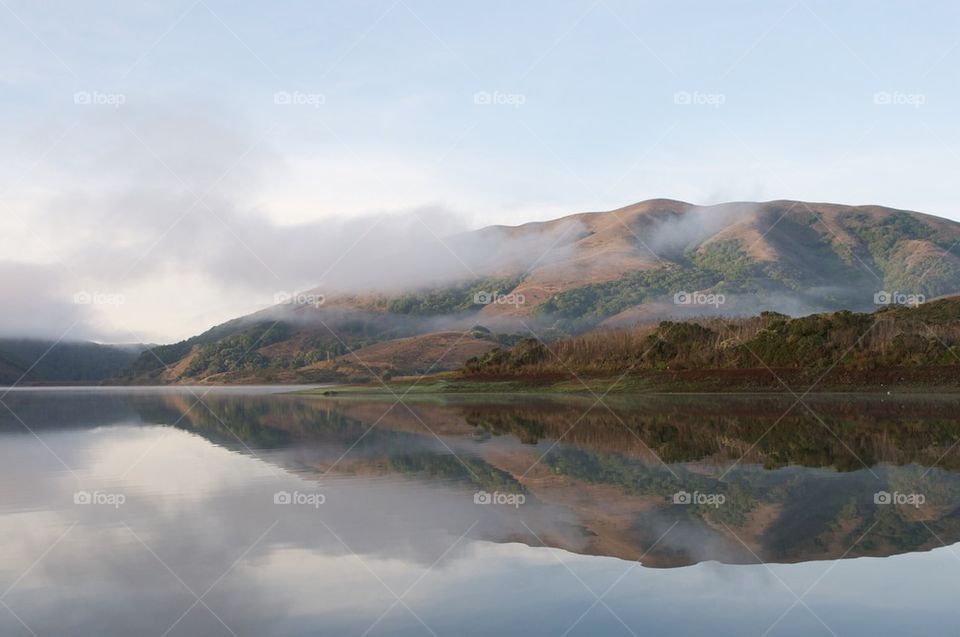 Foggy lake and hills
