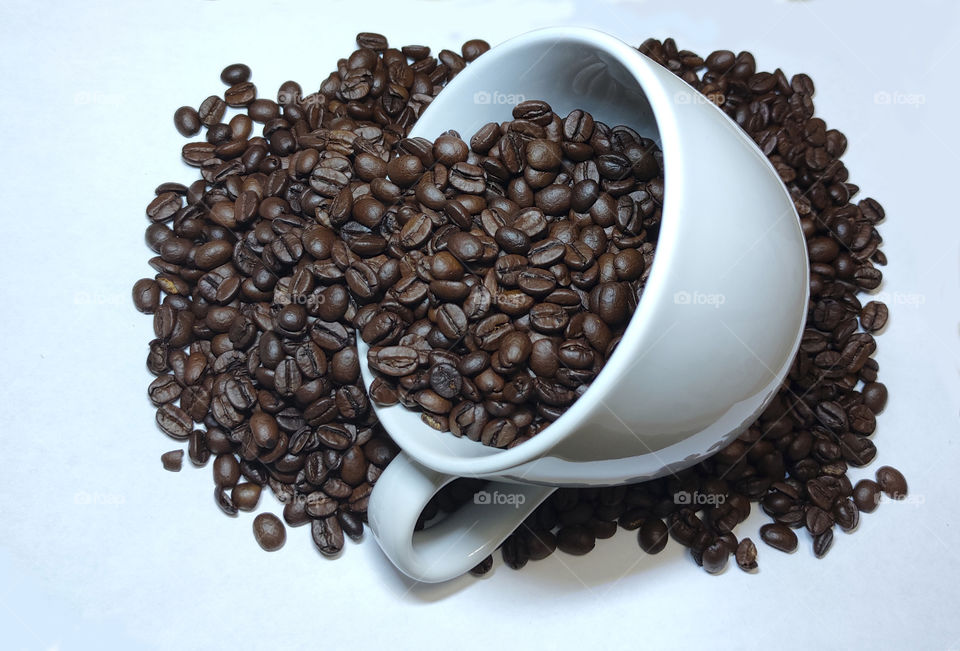 ceramic cup with coffee beans