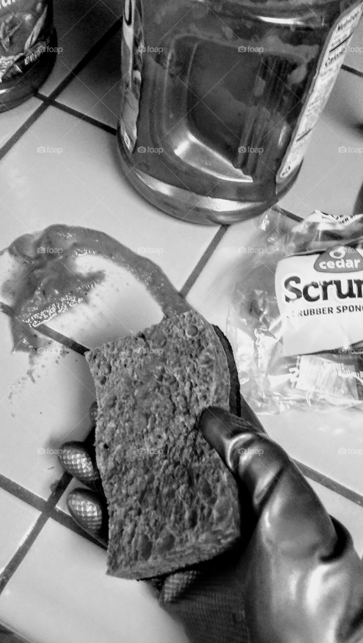 Cleaning up with a sponge and gloves