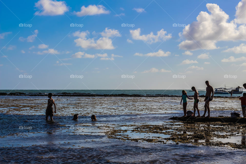 people cooling off on coral beach