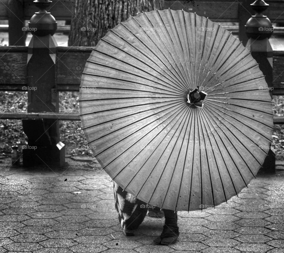 Woman standing behind umbrella