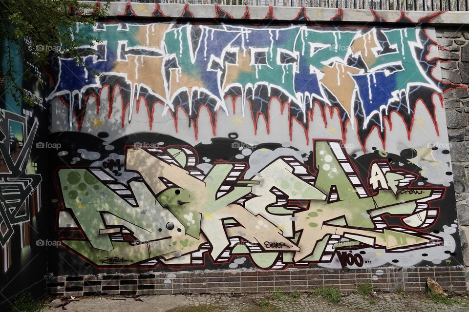 Colorful abstract graffiti and lettering on the wall by the path near Vitkov in Prague, Zizkov.