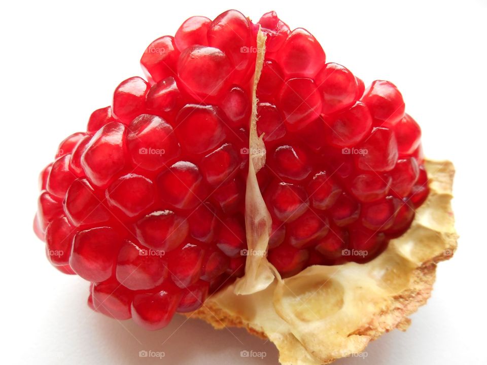 red pomegranate seeds healthy food white background