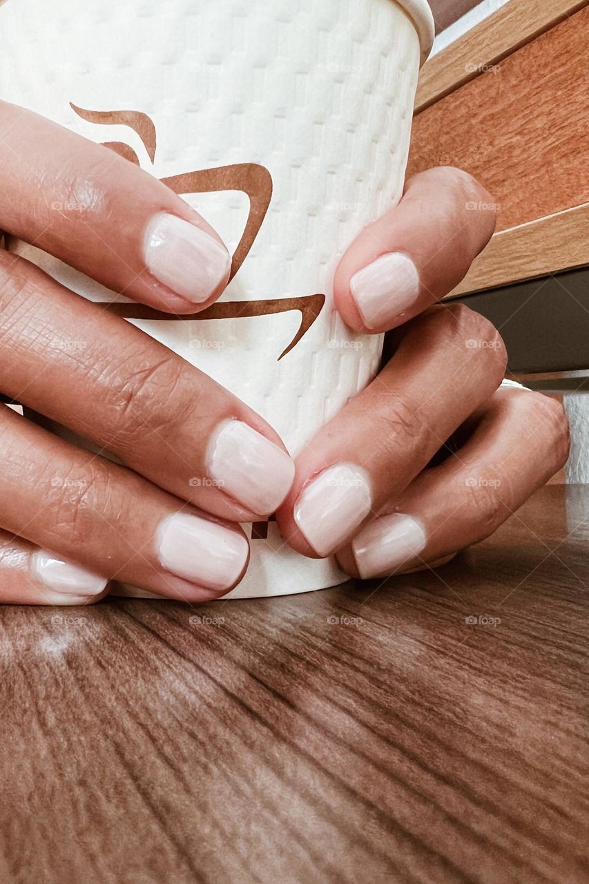 A person holding a coffee 