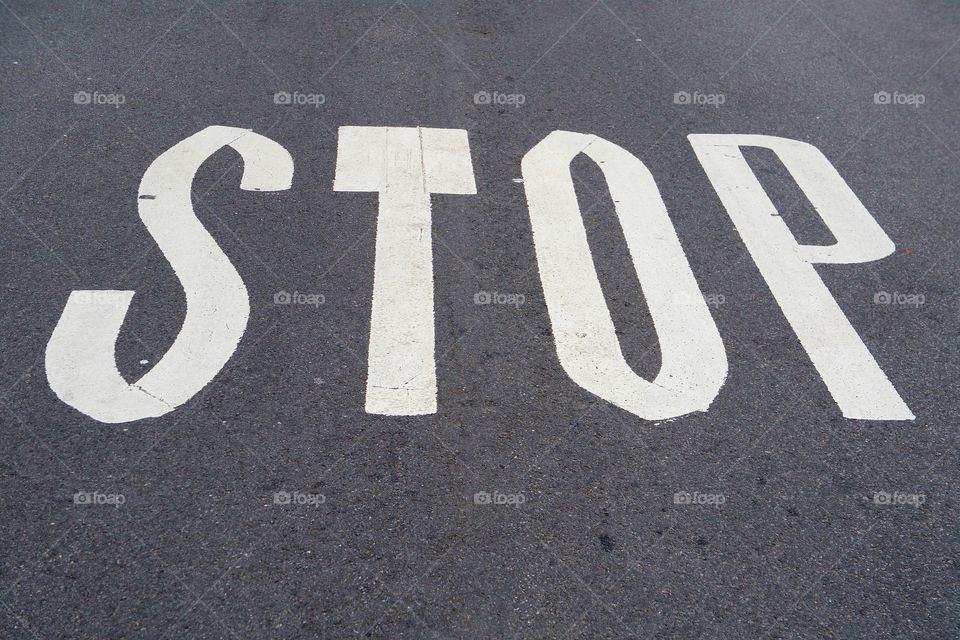 A painted word "STOP" on the pavement of a street in Manhattan, New York City..