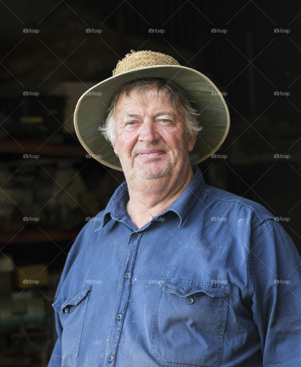 Portrait of a mddle-aged farmer wearing a hat