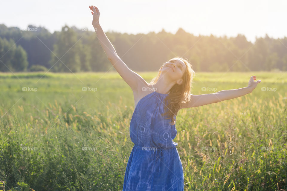 Young woman enjoying summer in the countryside