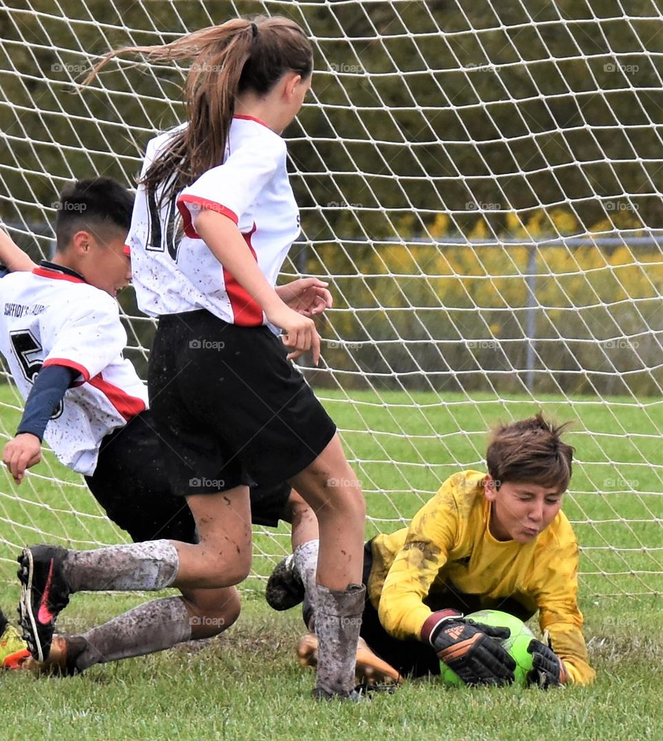 Goalie protecting the soccer ball