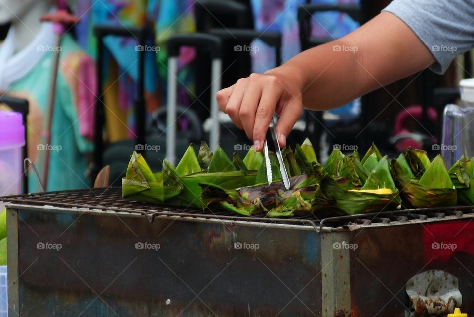 Close-up of a person's hand preparing food