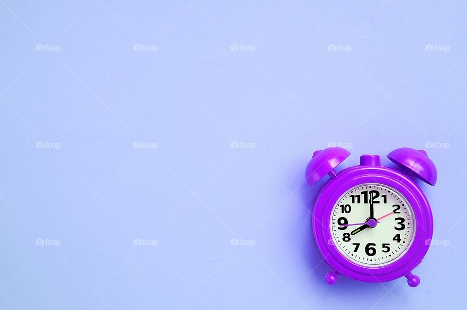 Clock isolated on purple background 