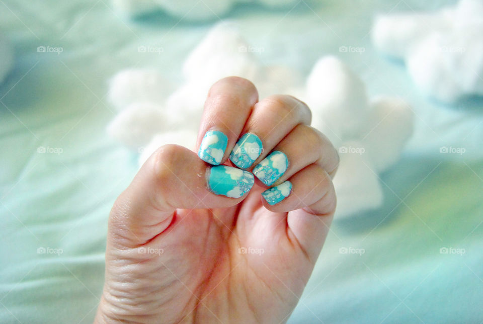 Clouds and rain nail art design. cotton balls as clouds in background