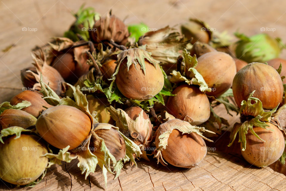 Hazelnuts on an old wood background
