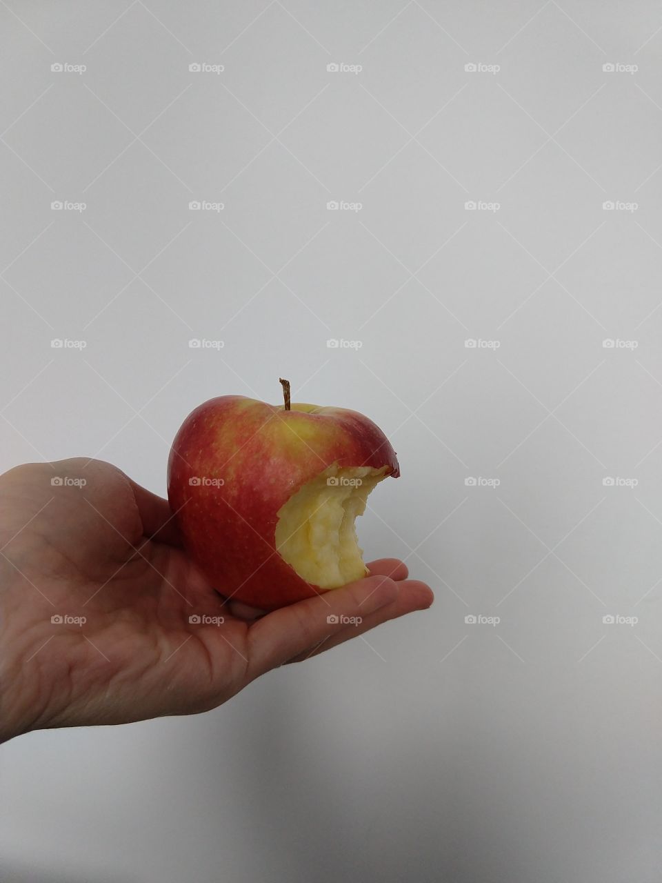 Hand holding an apple with a bit part. Slovakia