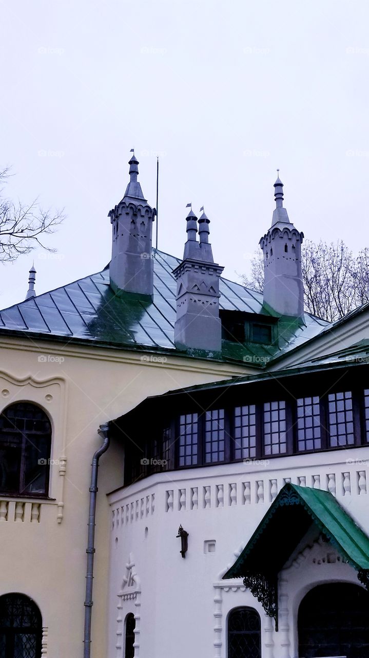 Chimneys in the form of outlandish towers adorn the roof of the building