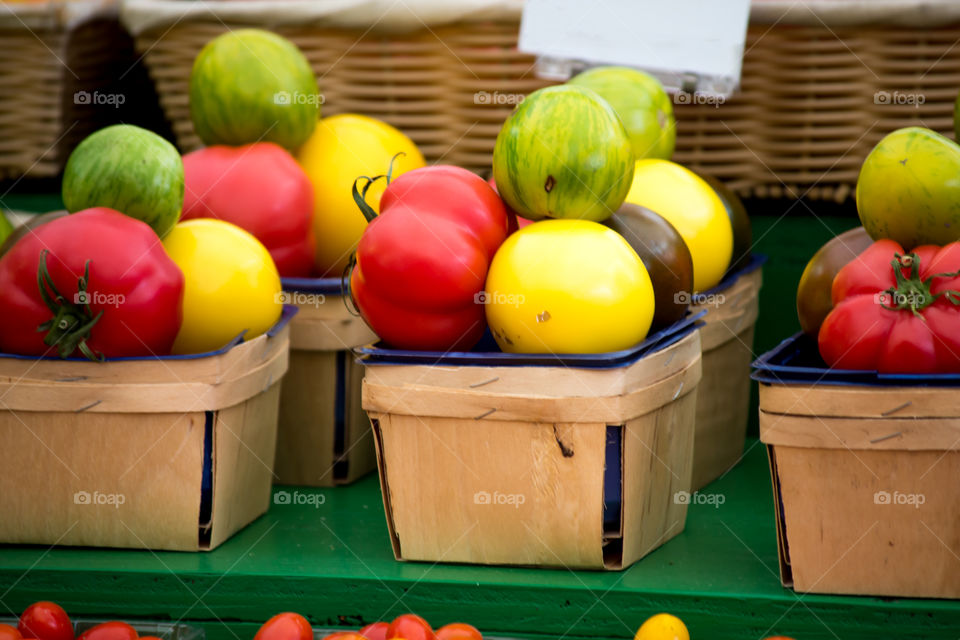 Beautiful colorful farmers market organic heirloom tomatoes in baskets 