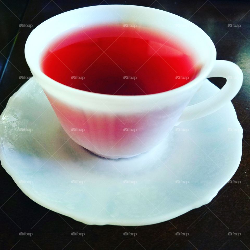 hibiscus tea in a milkglass teacup