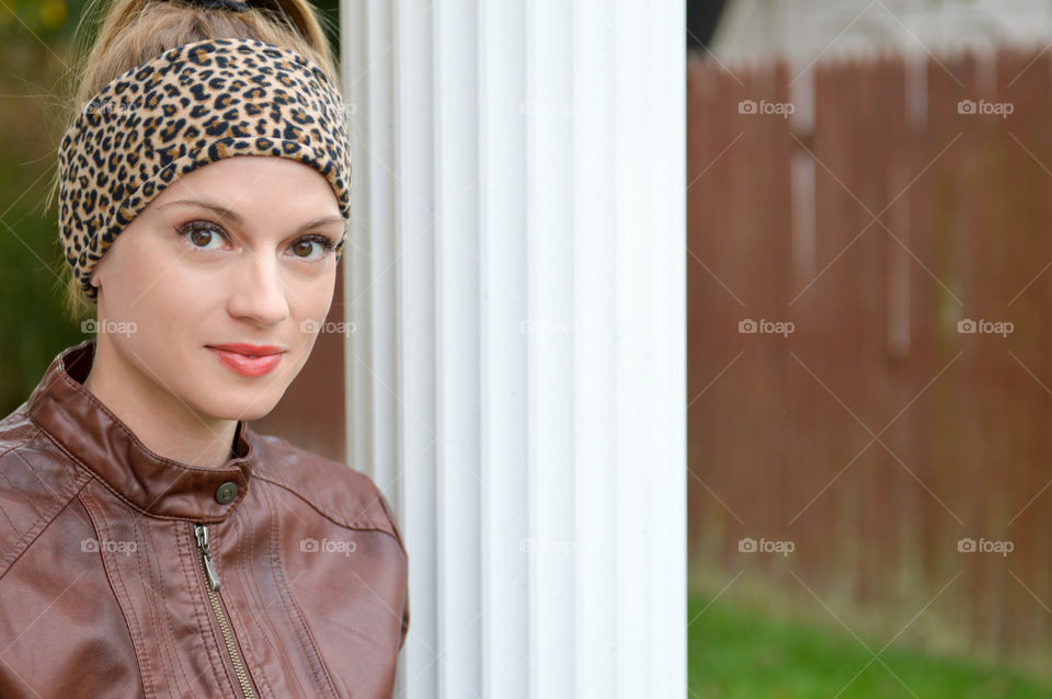 Woman wearing a leopard print fleece headband outdoors