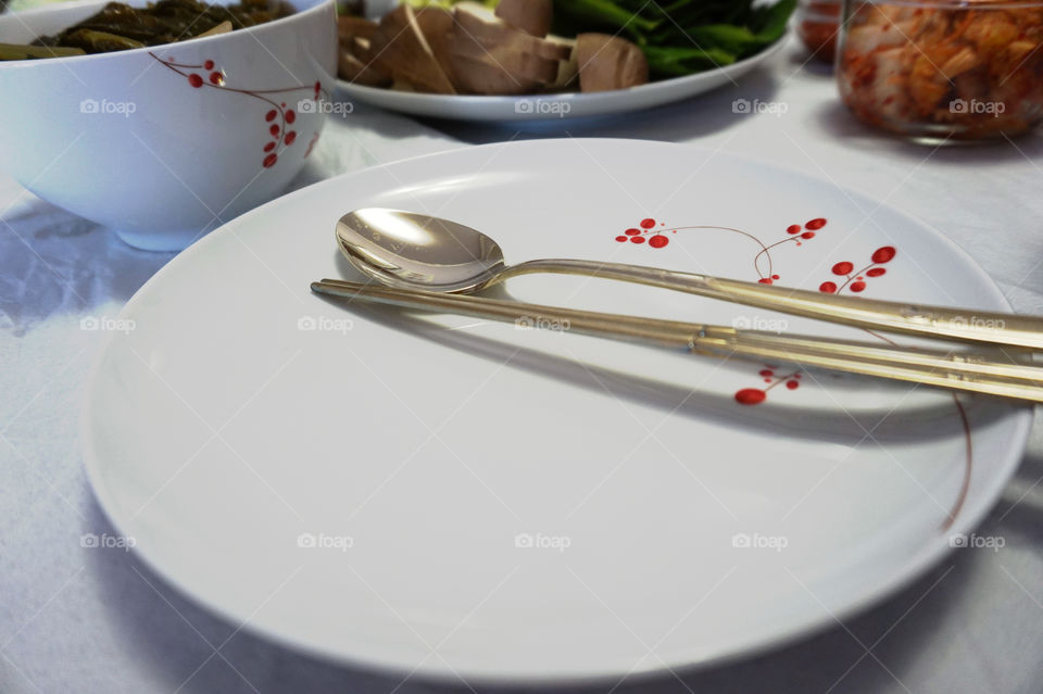 plate with chopsticks and spoon