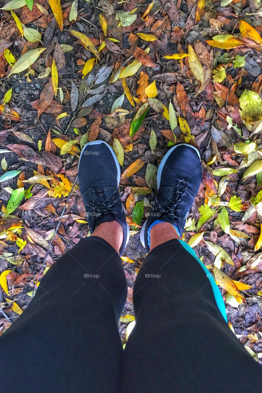 Human foot on the leaves