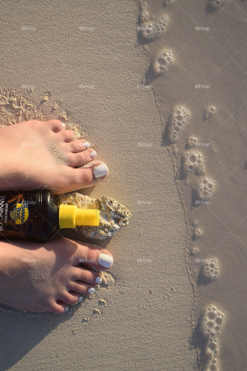 Standing By The Beach With Tan Oil