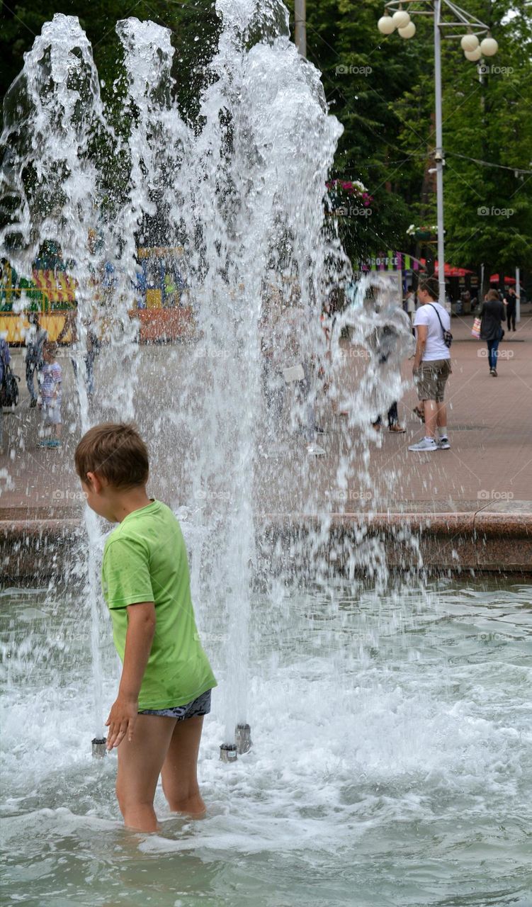 children in water fountain urban nature summer time