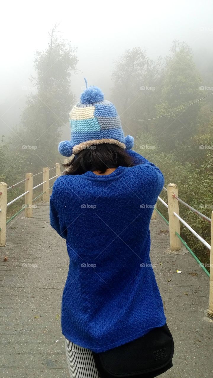 Someone clicking the beautifully converging lines of the bridge in the middle of a fog.