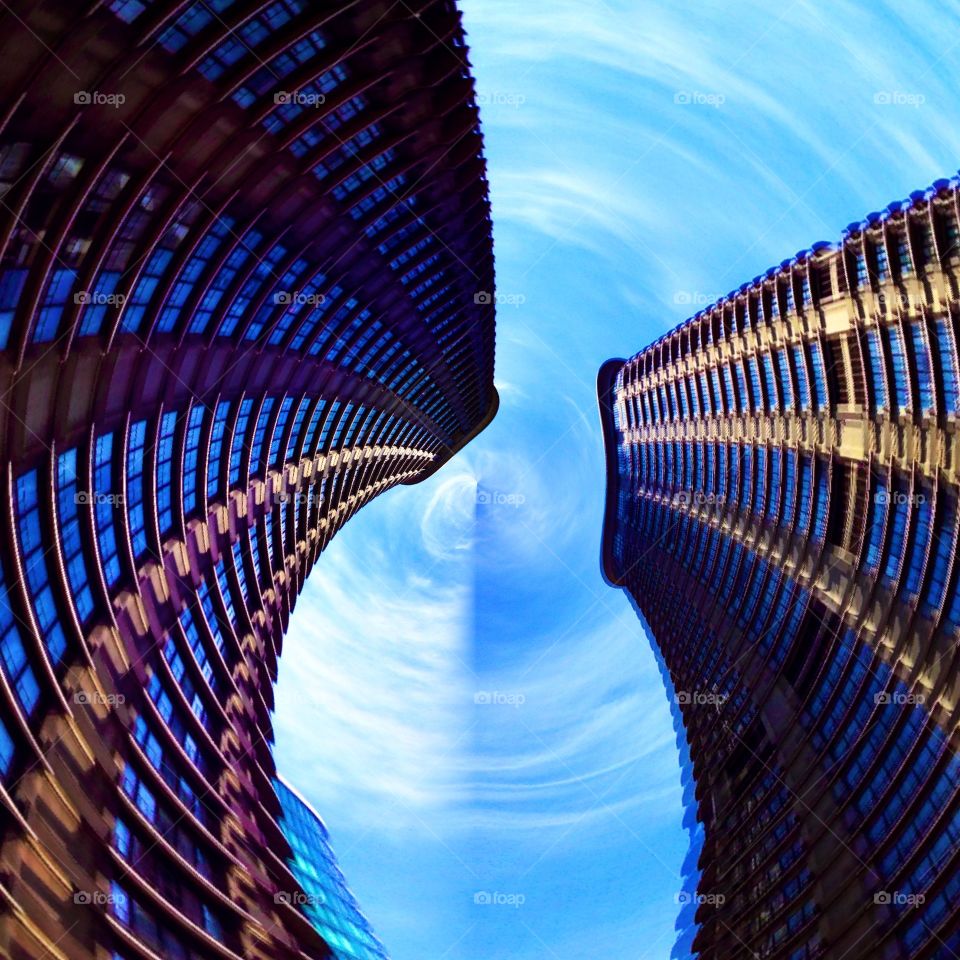 Looking Up at Skyscrapers. Two blue skyscrapers against sky