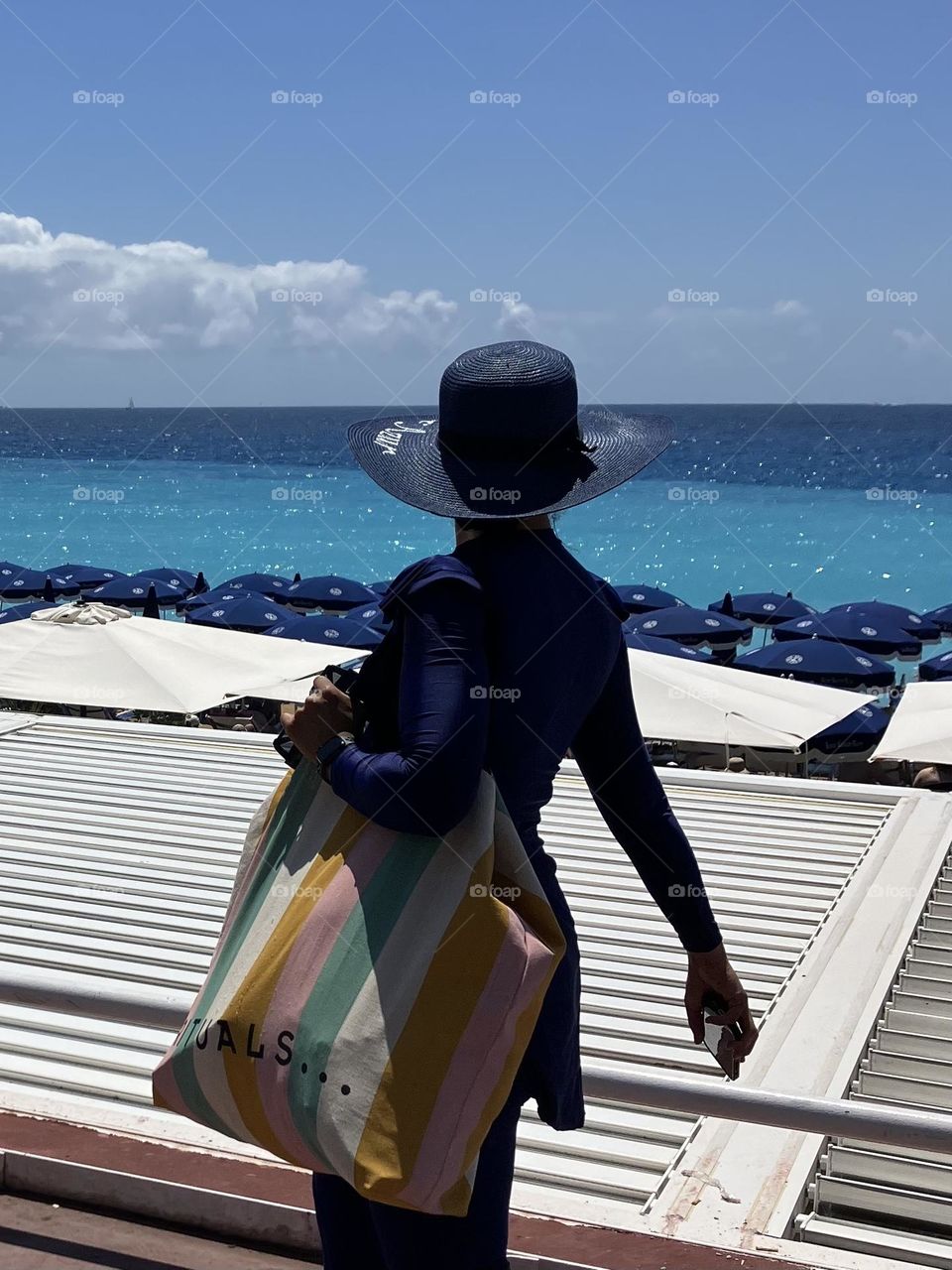 Woman walking along seashore 