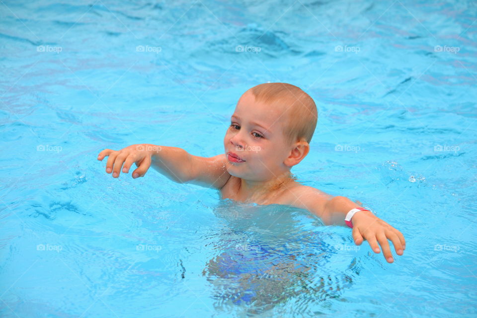 Boy swimming in a pool