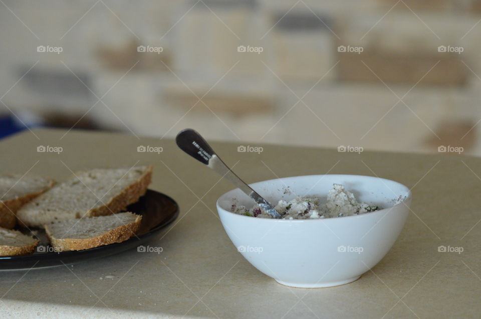 Healthy breakfast- white cottage cheese with onions, chives, salt and pepper on bread