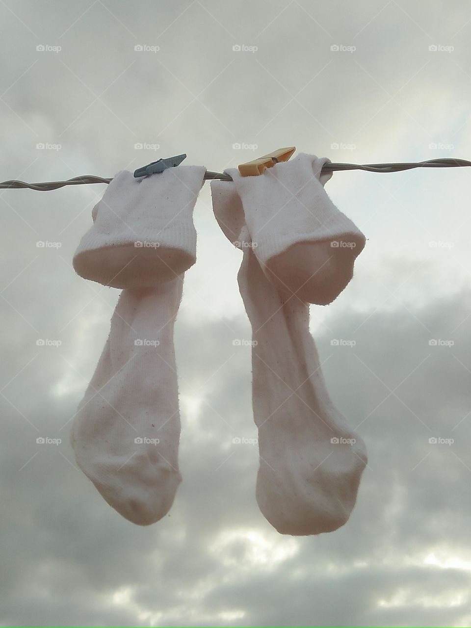 Socks hanging over the laundry rope.