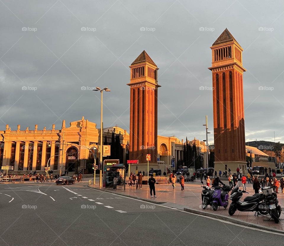 Barcelona at Plaza Espania at sunset - incredible colors of the sunset illuminating the red bricks of the towers