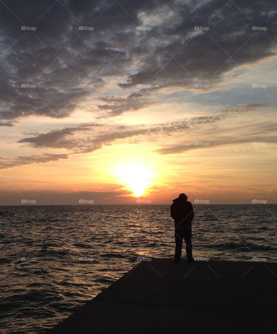 Rear view of person standing on pier