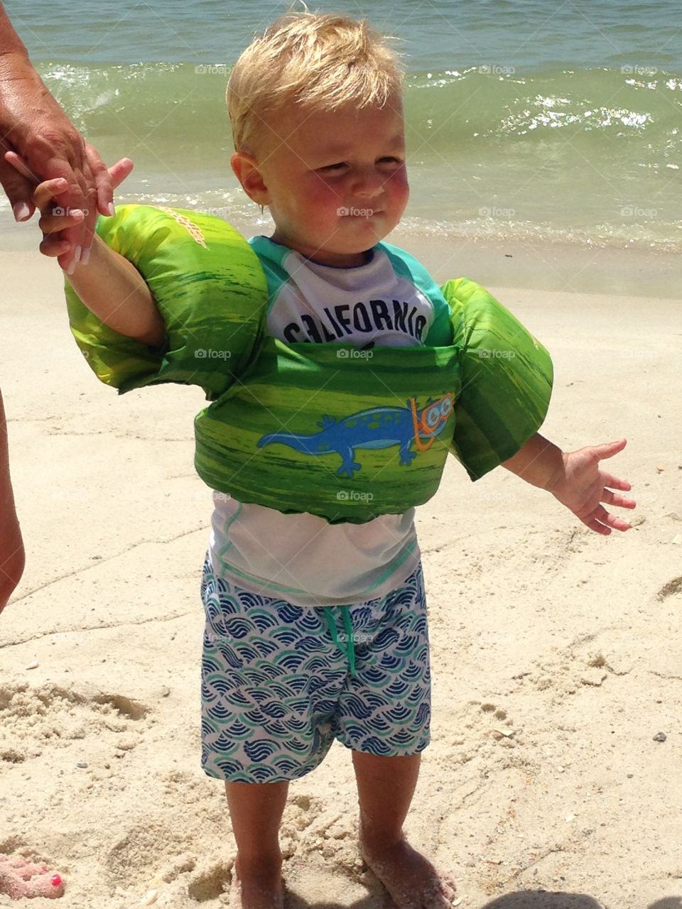 Little boy with arm band at beach