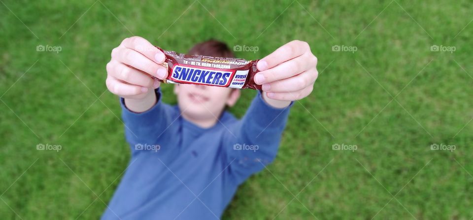 boy holding snickers