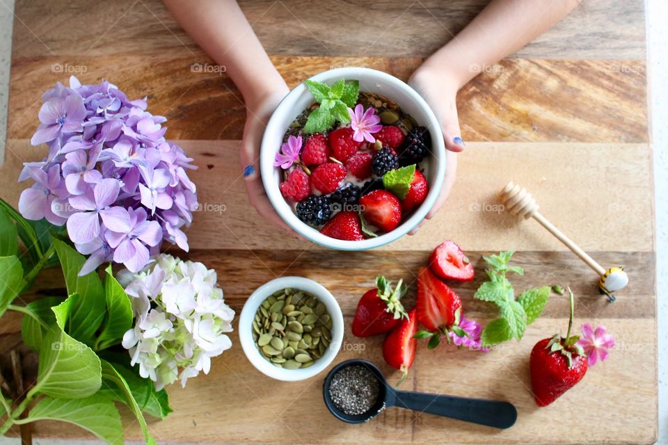 A person holding breakfast in bowl