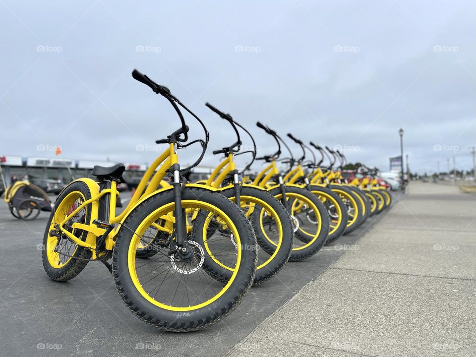 Many yellow bicycles on the parking 