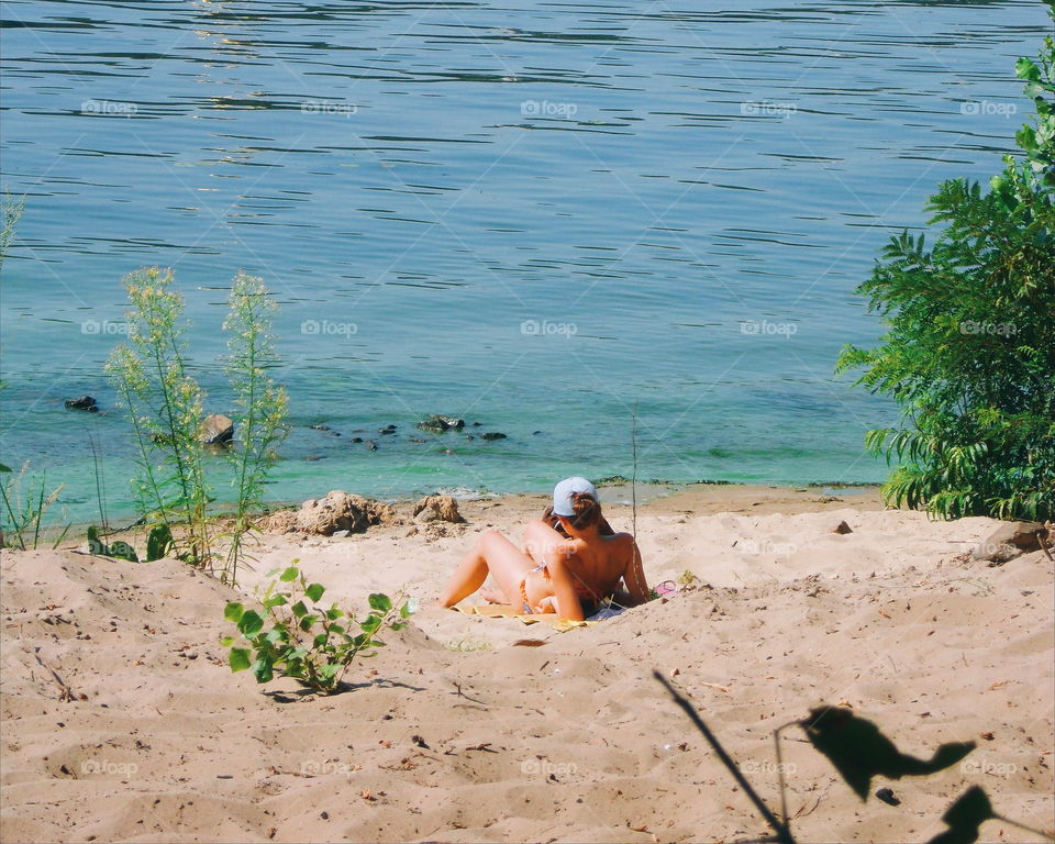 girl sunbathing on the plan in Hydropark in the city of Kiev