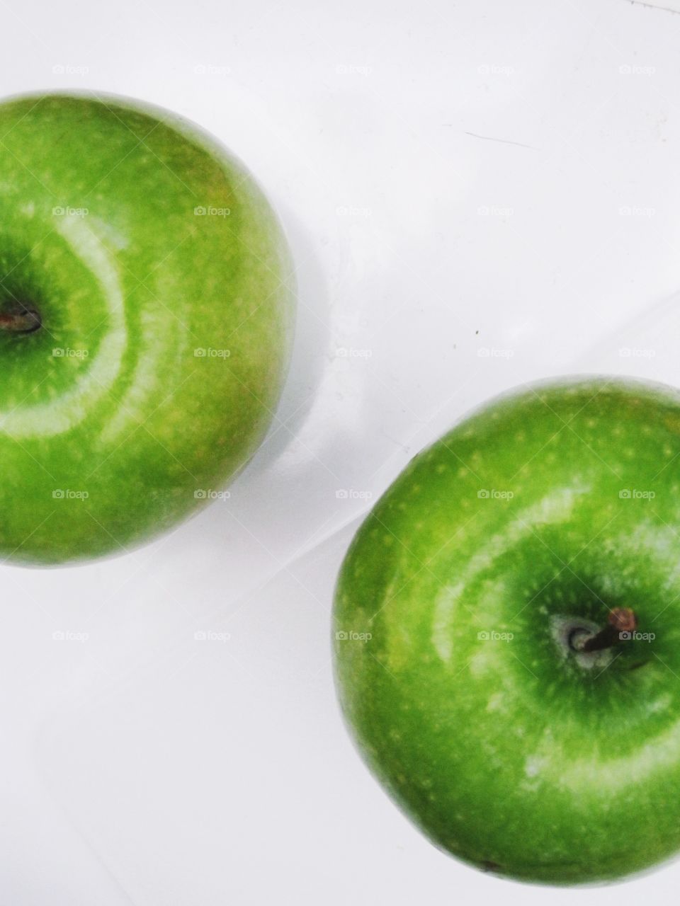 Two green apples on a white background 