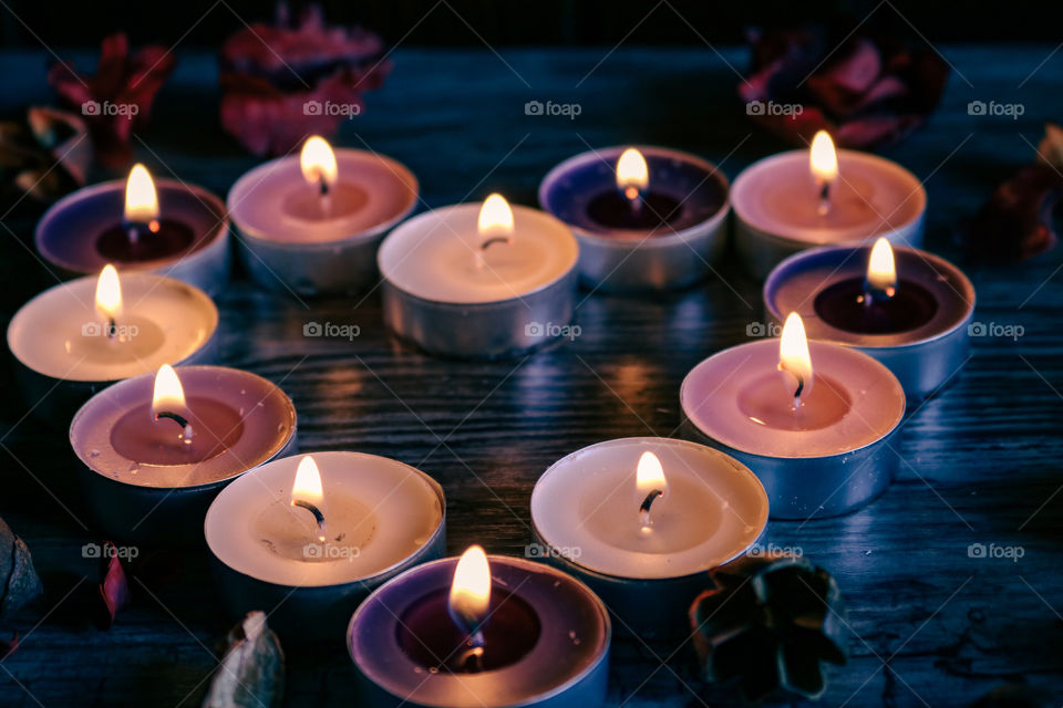 Candles and flowers in the shape of heart