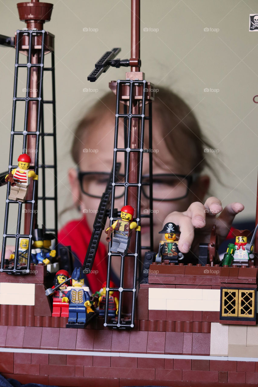 Child playing with Lego Pirates